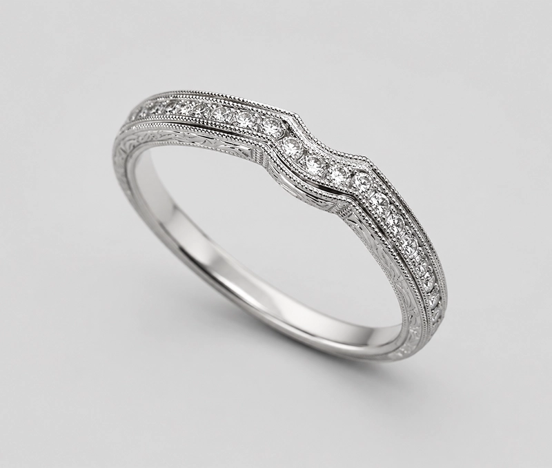 Silver diamond ring with intricate design.